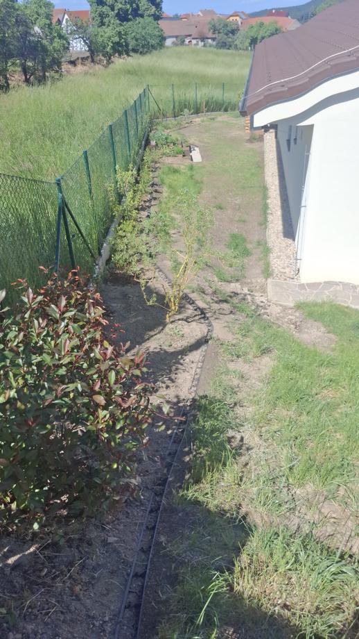 Upravený svah u plotu s mladou výsadbou – Drobná řemesla